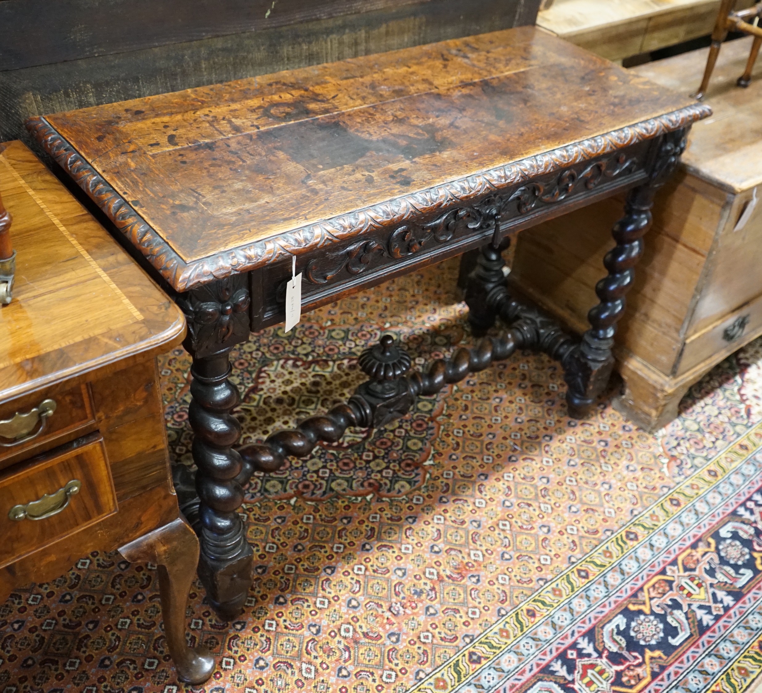 A late 19th century Flemish carved oak side table, width 100cm, depth 45cm, height 75cm